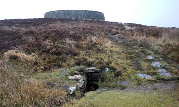 The holy well of St Patrick, on the hill below the Grianan. Photo via Wikimedia Commons.